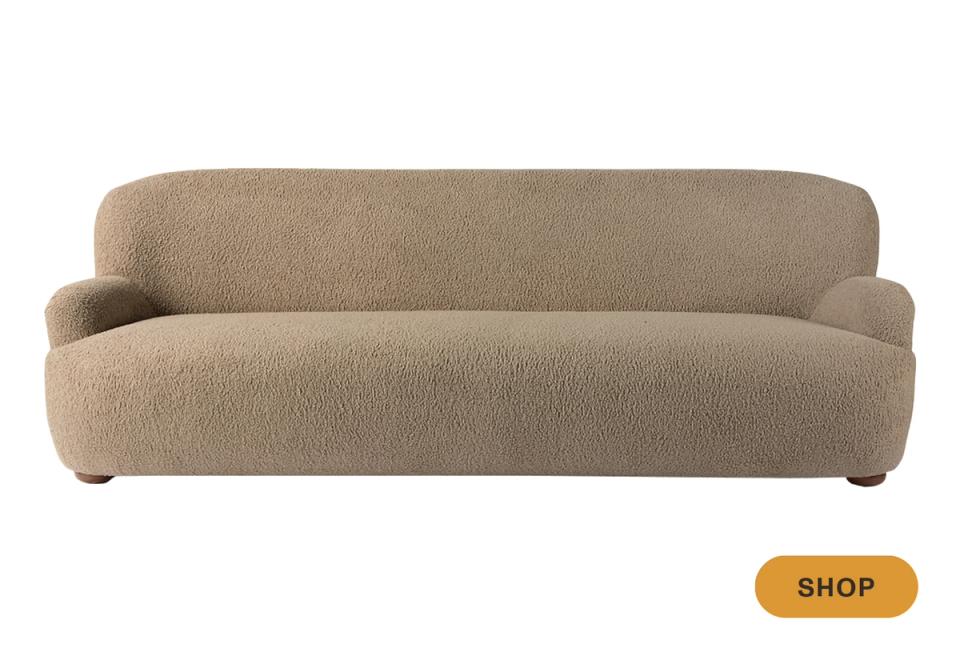 Curved contemporary camel sofa with minimalist sculptural silhouette