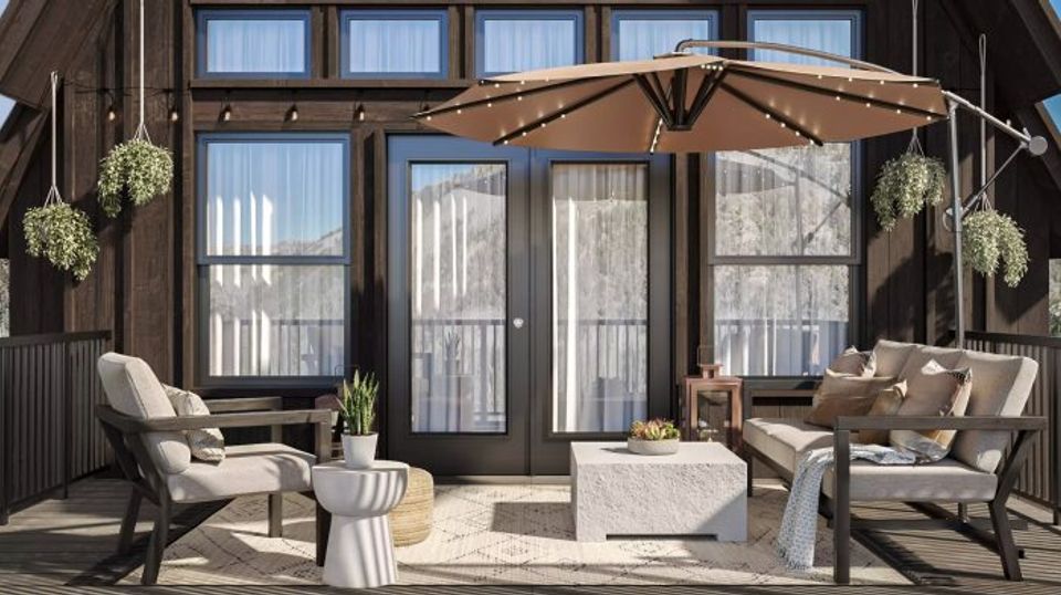 Transitional lounge with dark timber framing, neutral upholstery, natural light, and modern farmhouse warmth and proportions.