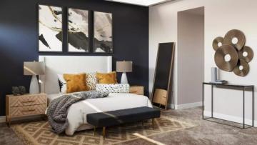 Eclectic bedroom with black accent wall, warm mustard and patterned pillows, natural wood nightstand, and woven wall art for balanced contrast