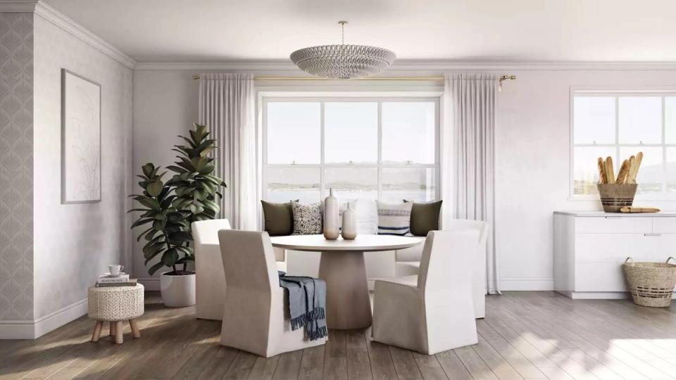 Clean contemporary dining room with round white table, neutral upholstered chairs, and abundant natural light
