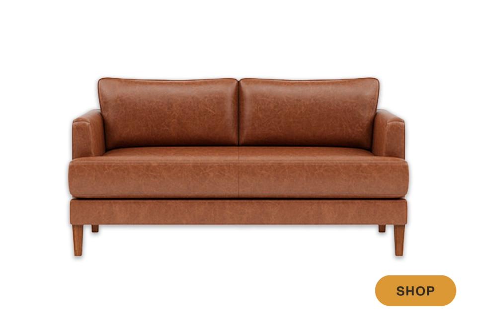 Mid-century modern cognac leather sofa with warm wood legs and compact frame