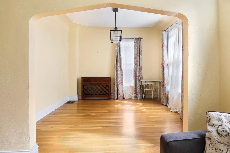 Transitional dining room with warm wood tones, cream walls, and classic architectural details