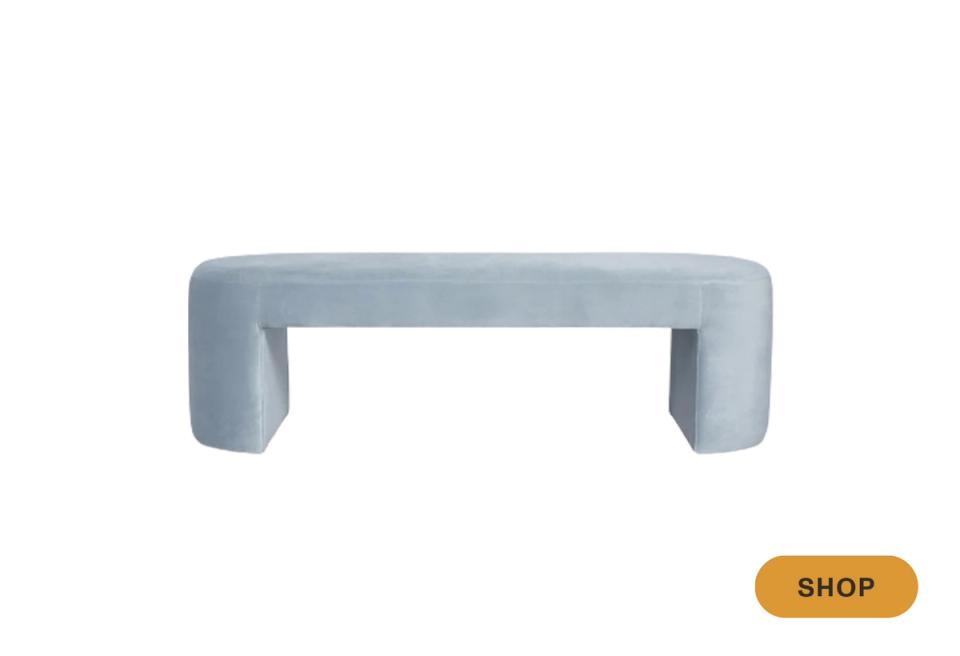Contemporary curved bench in soft blue-gray upholstery with organic rounded form