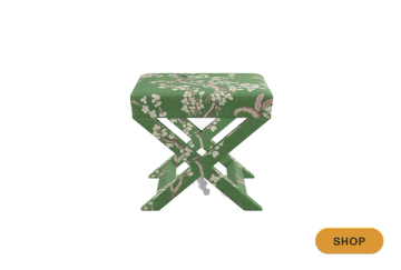Botanical patterned bench seat in sage green with floral motif and X-frame legs