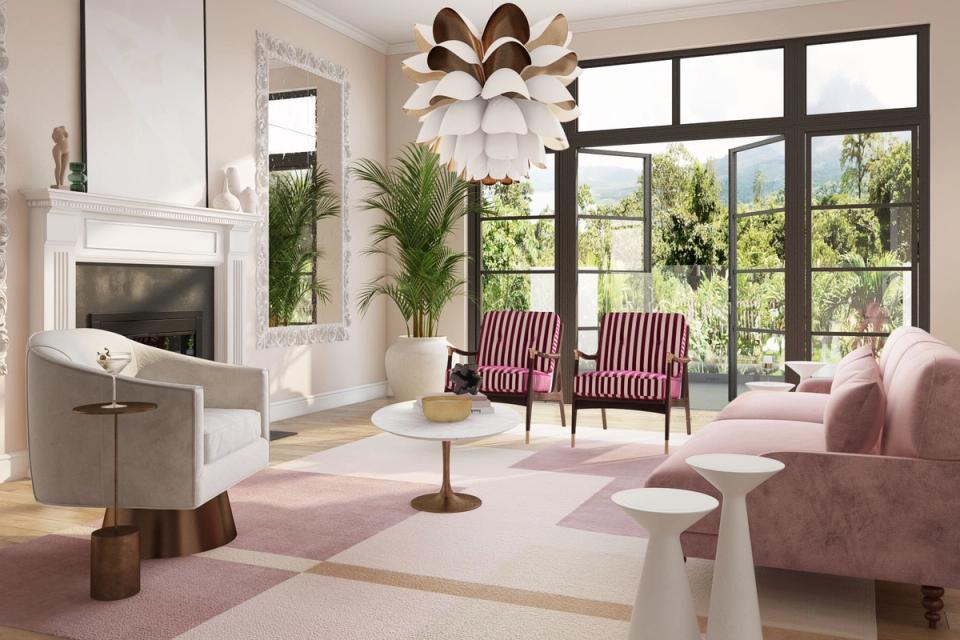 Soft pink and cream living room with mid-century chairs, fireplace, and floor-to-ceiling windows overlooking greenery