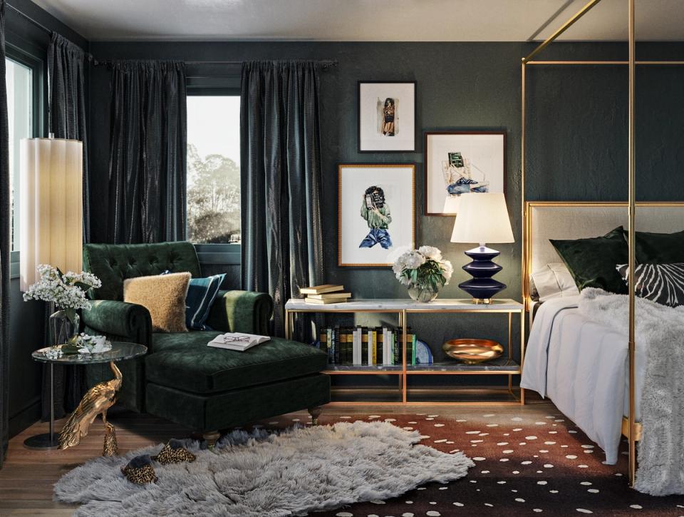 Luxe bedroom with deep forest green walls, brass canopy frame, and sophisticated emerald velvet seating