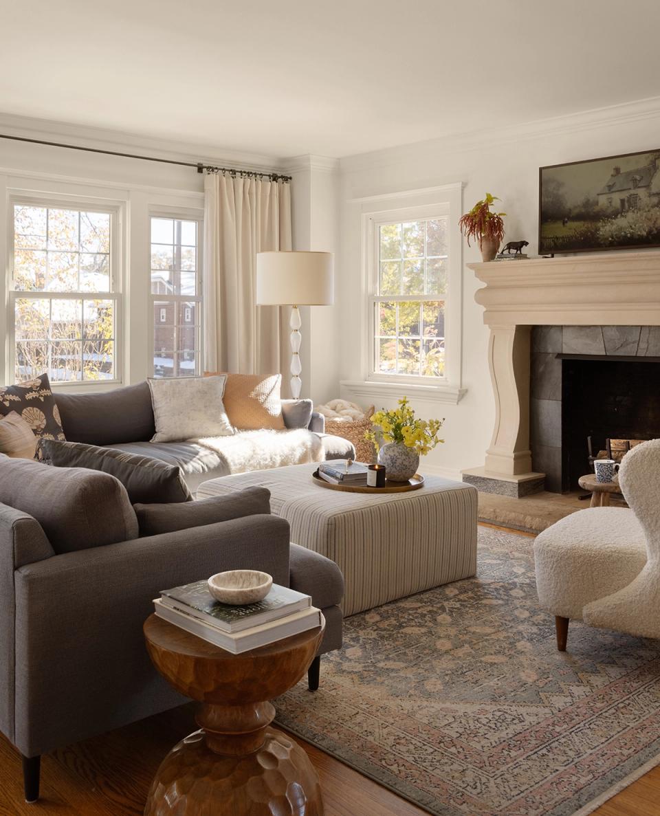 Refined traditional living room with gray upholstery, fireplace, and warm neutral accents