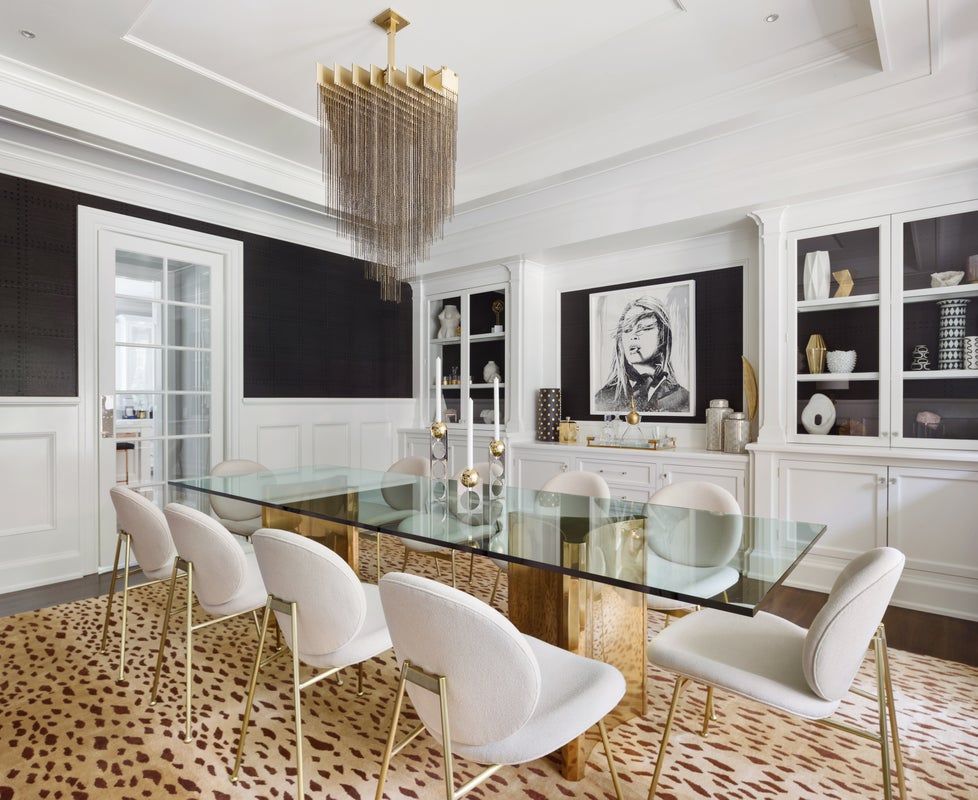 Sophisticated dining room with black and white color blocking, brass accents, and modern glam aesthetic