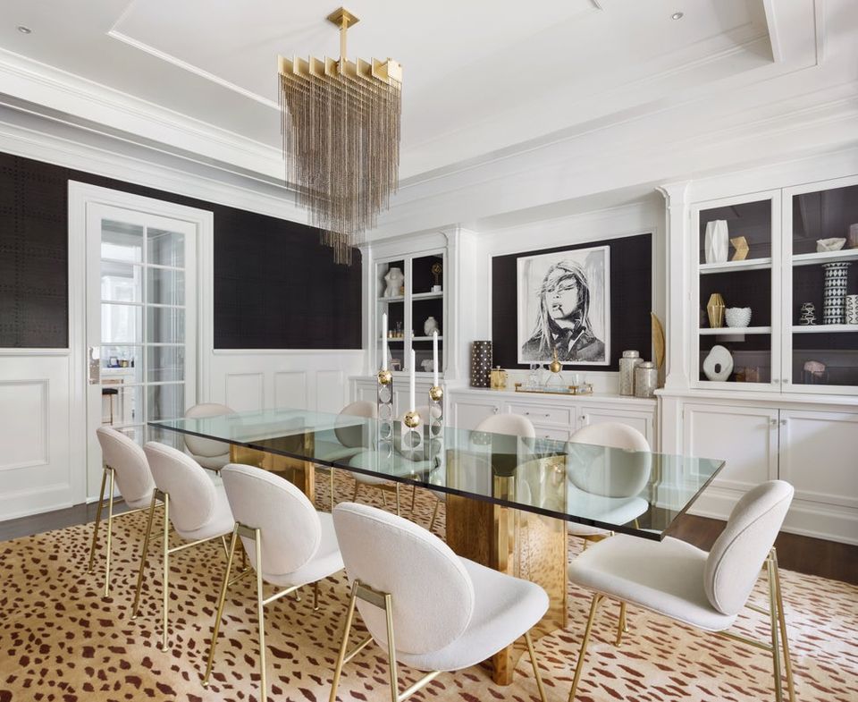 Sophisticated dining room with black and white color blocking, brass accents, and modern glam aesthetic