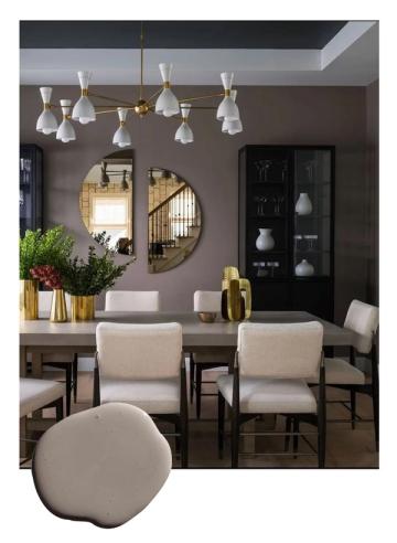 Sophisticated dining space with taupe walls, brass pendant lighting, round mirrors, and cream seating in contemporary chic design