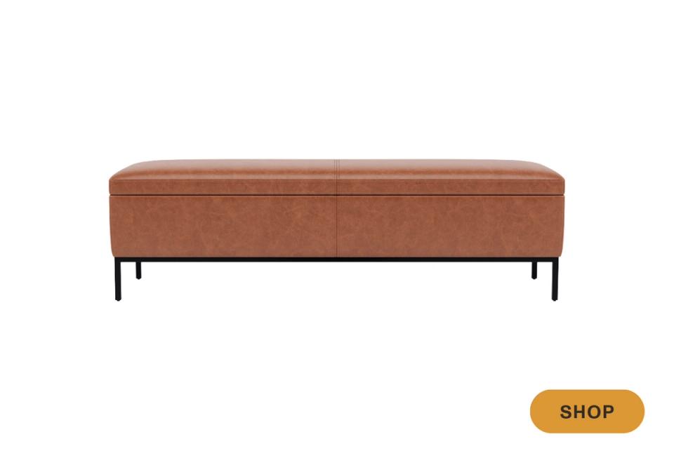 Cognac leather bench with sleek black metal legs, exuding mid-century modern sophistication