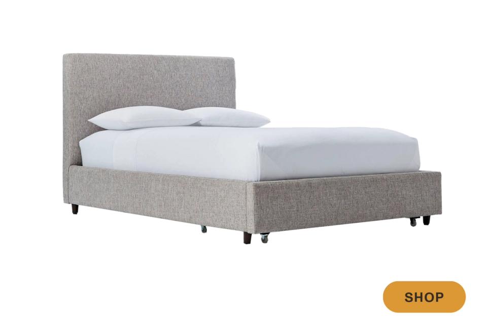 Contemporary gray upholstered storage bed with clean lines and neutral tones