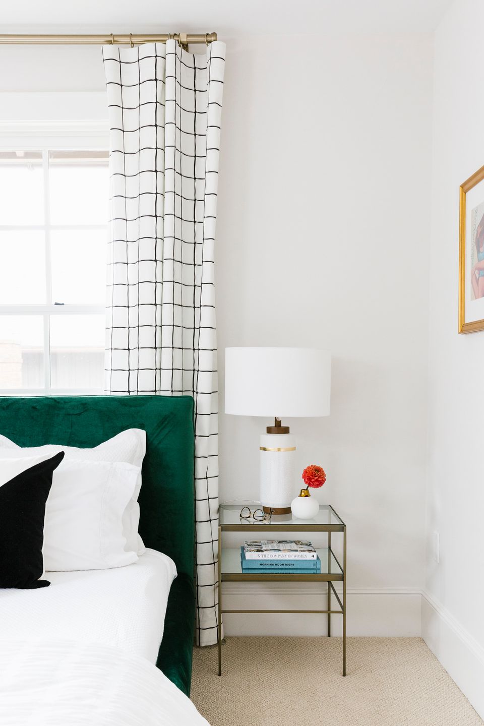 Modern preppy bedroom with emerald velvet headboard, grid-patterned curtains, and clean white walls
