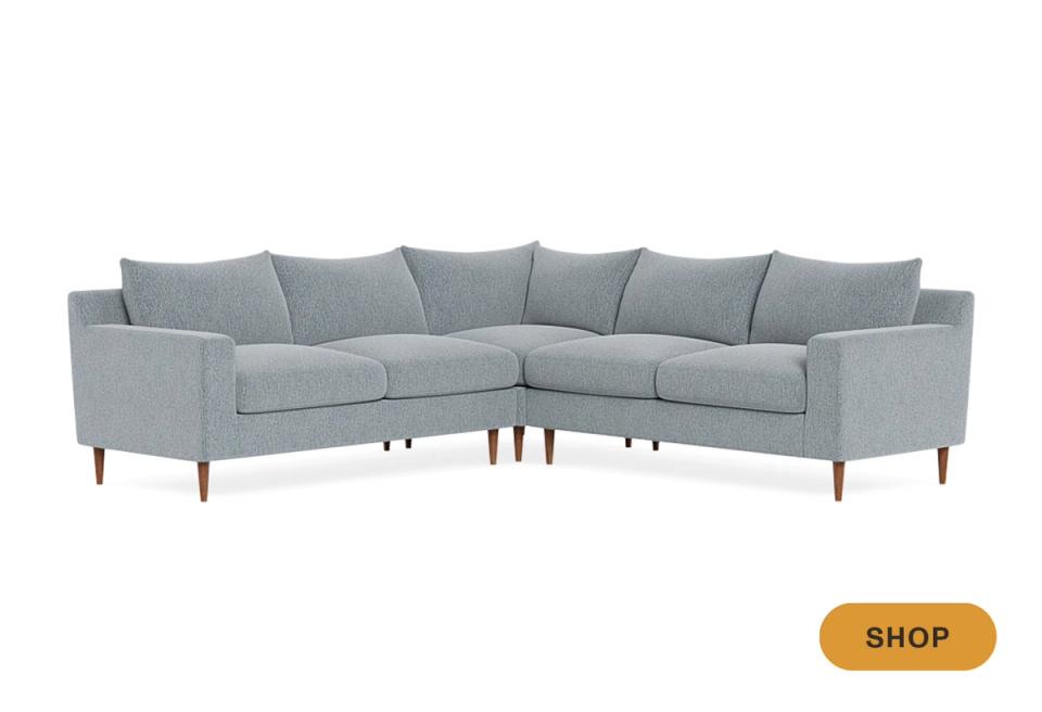 Contemporary gray-blue sectional with mid-century tapered legs and angular silhouette