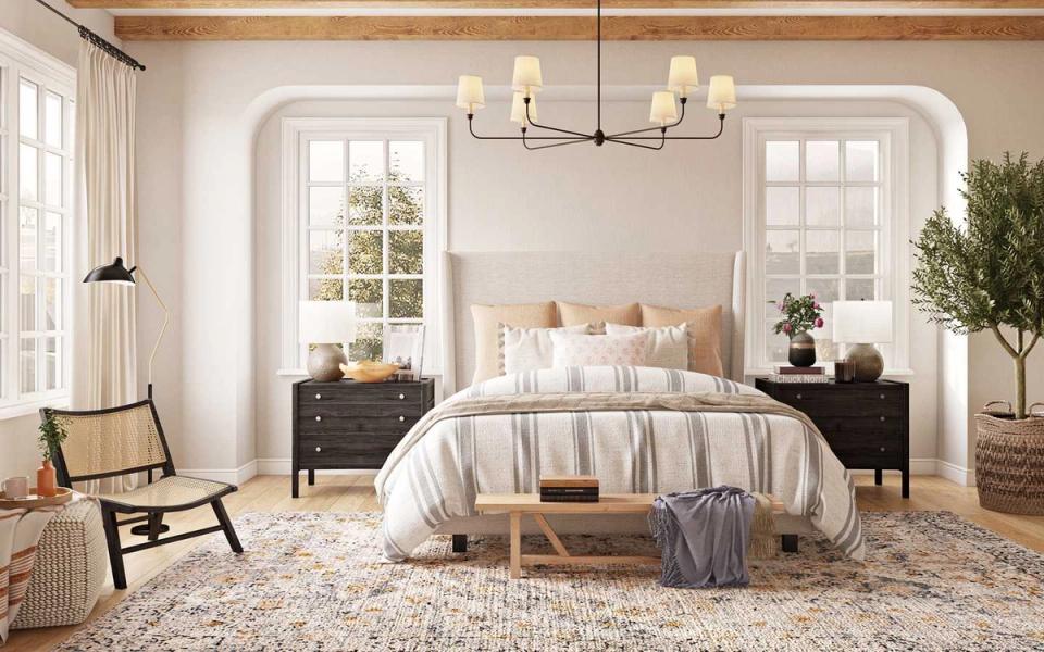 Serene modern bedroom with soft greige walls, natural wood bed frame, striped bedding, and abundant natural light from arched windows