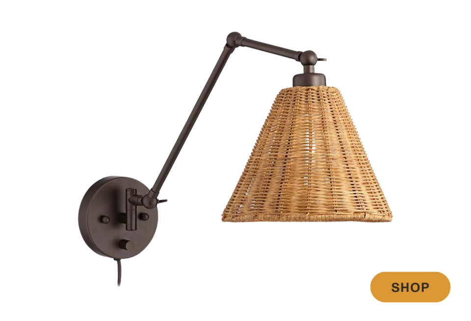 Industrial rustic wall sconce with articulating black arm and woven wicker cone shade