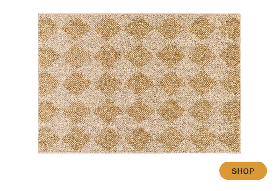 Warm neutral outdoor rug featuring traditional diamond lattice pattern in earthy tones