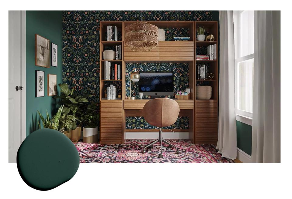 Bold jewel-tone green accent wall with patterned wallpaper, natural wood shelving, and eclectic mid-century furnishings in contemporary den