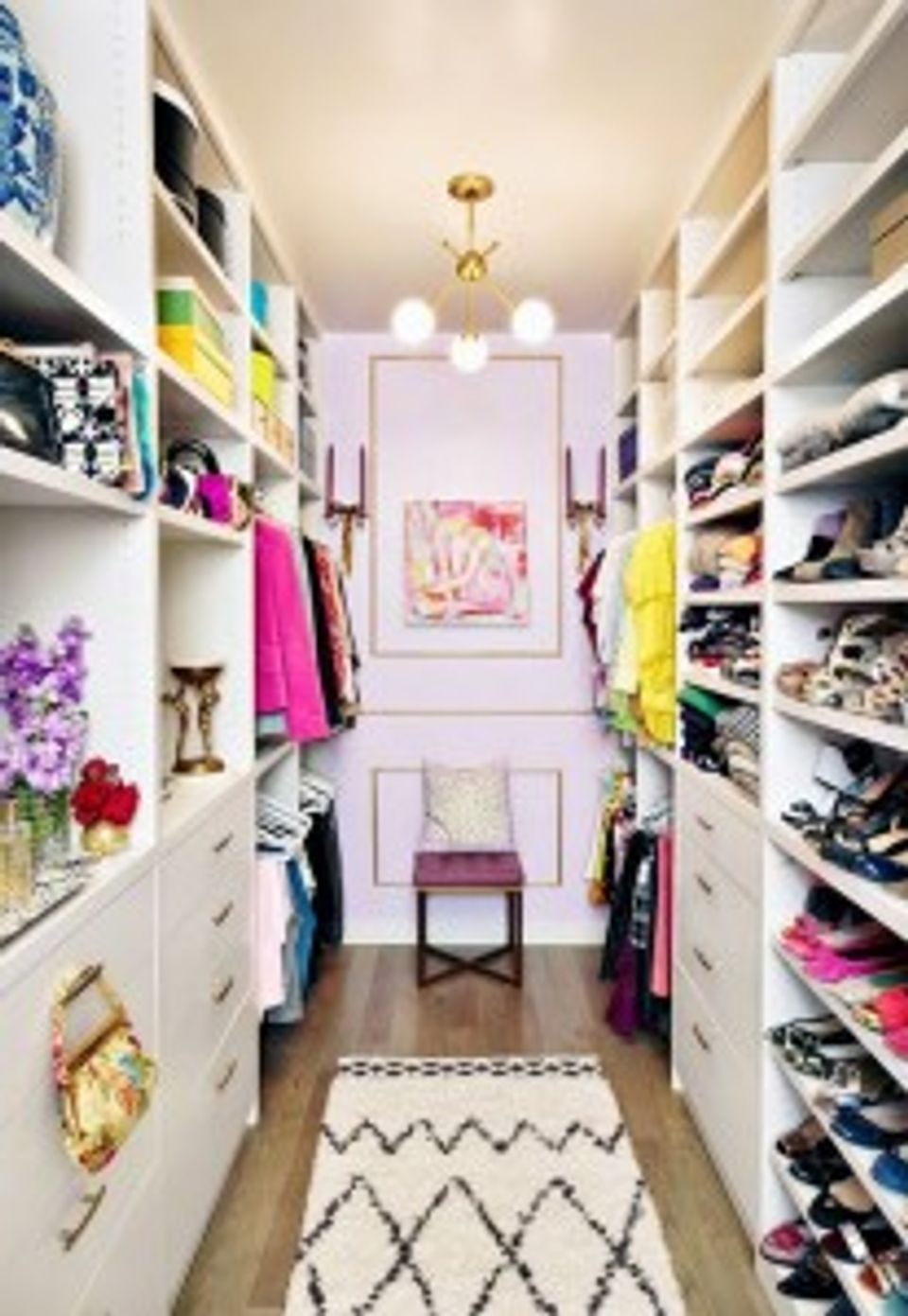 Modern minimalist walk-in closet with pastel lavender walls and organized white shelving