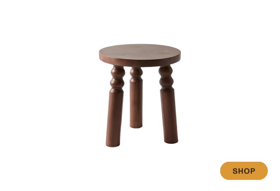 Traditional dark wood accent table with turned legs and round top for classic living room charm