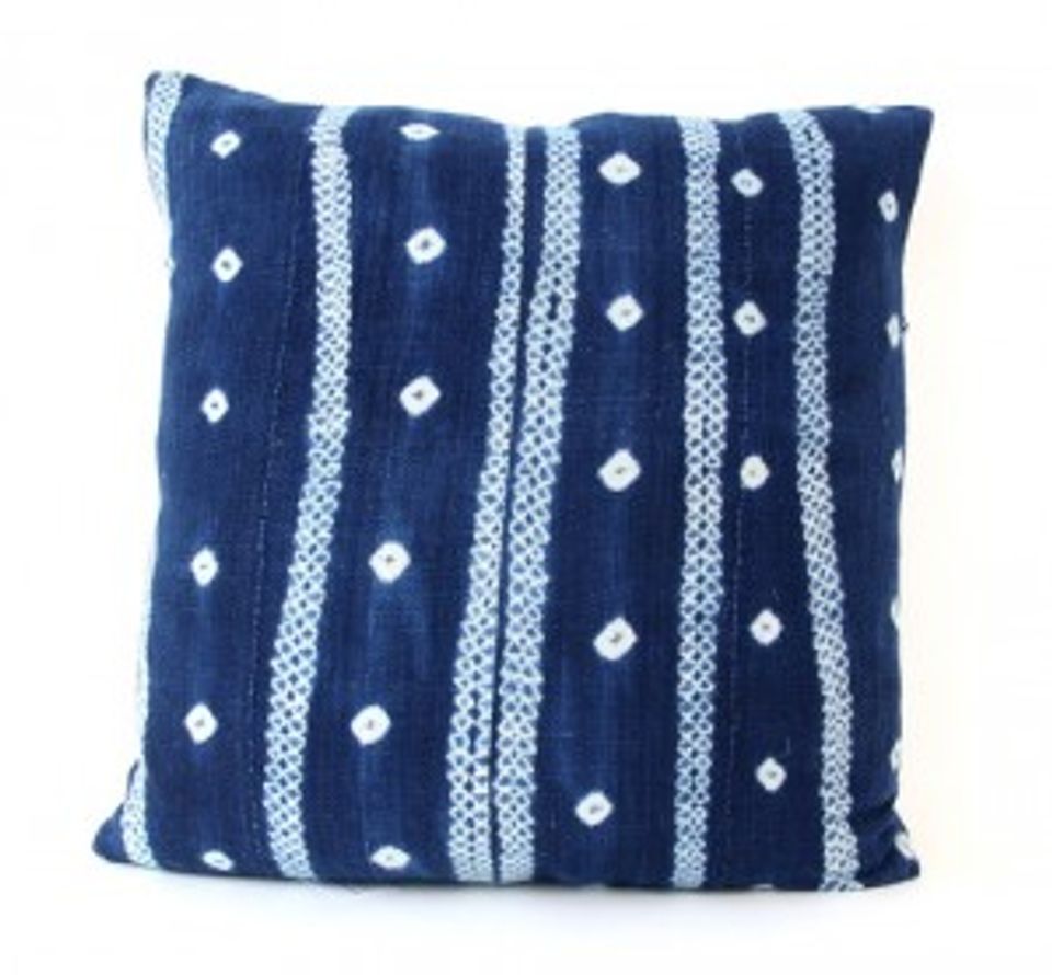Navy knit pillow with white geometric dots and stripes in modern coastal style