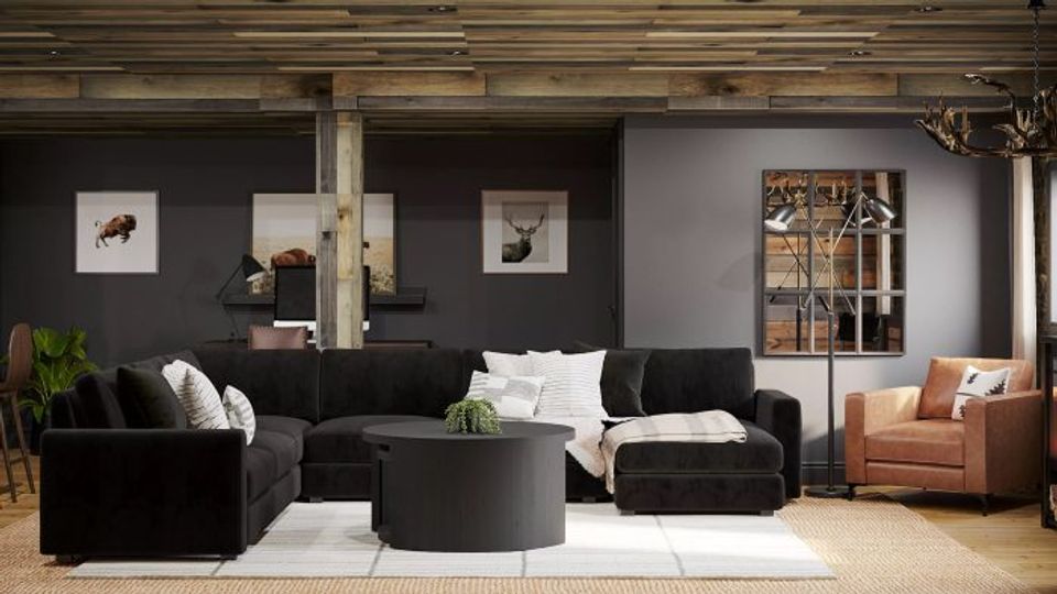Modern living room with dark charcoal walls, black furniture, and warm cognac accents creating sophisticated, moody elegance.