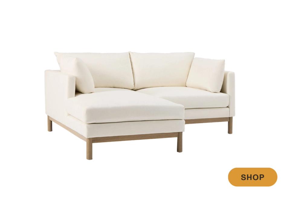 Scandinavian-inspired cream sectional with natural wood frame and minimalist design