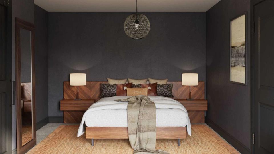 Modern dark bedroom with charcoal walls, warm wood bed frame, and sculptural pendant lighting