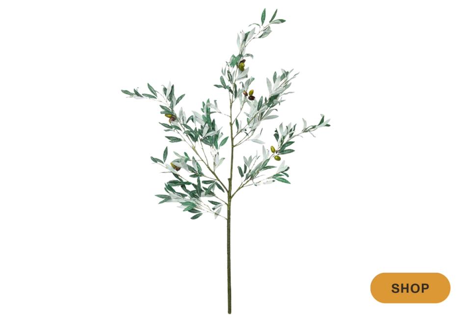 Botanical faux branch with delicate green foliage in contemporary arrangement