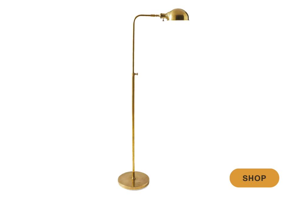 Modern brass arc floor lamp with minimalist dome head and adjustable arm design