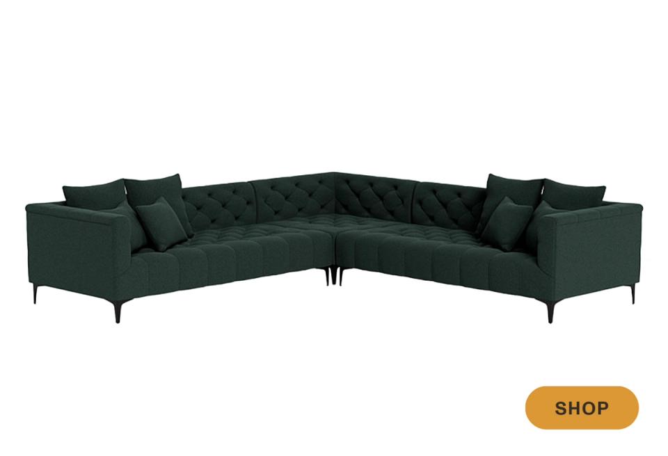 Modern dark forest green curved sectional with metal legs and contemporary styling