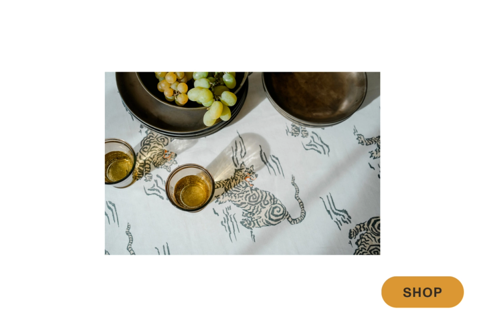 Culinary flatlay with olive oil, patterned linen, and botanical sketches in warm Mediterranean style