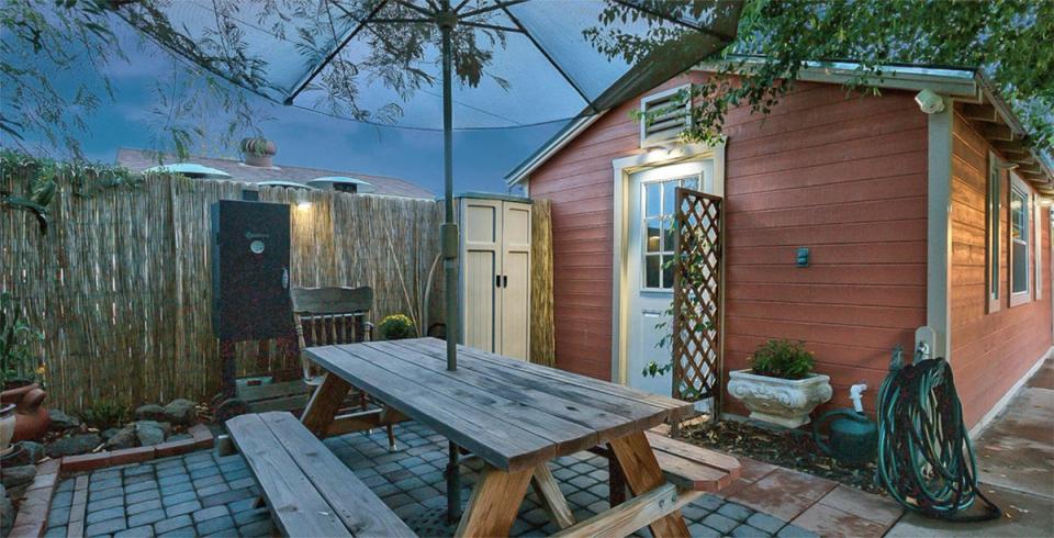 Rustic mid-century patio with warm wood tones, terracotta accents, and industrial elements