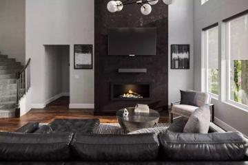 Contemporary living room with black fireplace accent wall, floating TV mount, black leather sectional, and minimalist lighting for bold sophistication