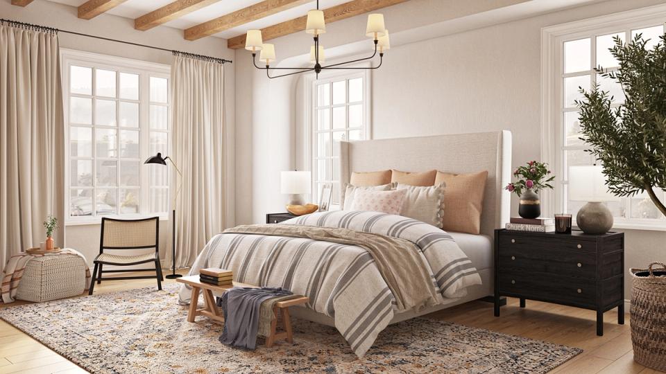 Airy coastal bedroom with striped bedding, exposed wood beams, soft neutrals, and potted greenery