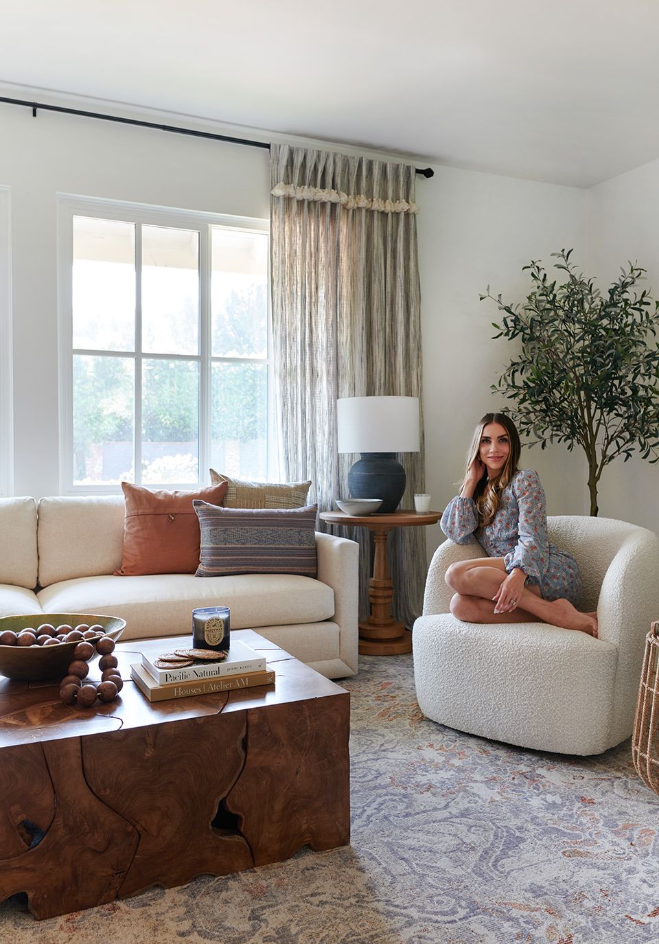 Transitional living room blending cream furniture, rust tones, and organic textures
