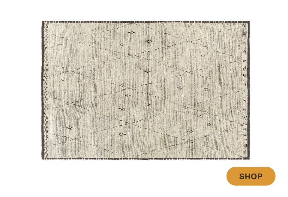 Understated botanical area rug in soft gray and cream with delicate scattered motifs