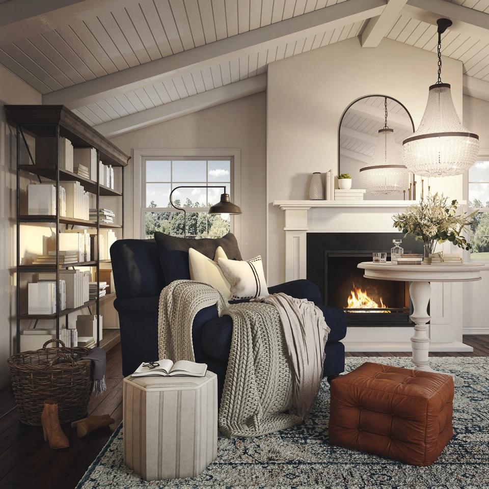 Cozy farmhouse reading corner with navy chair, white fireplace, and warm wood accents