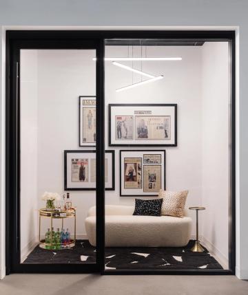 Glamorous dressing room nook with black framing, gallery wall, and sophisticated styling