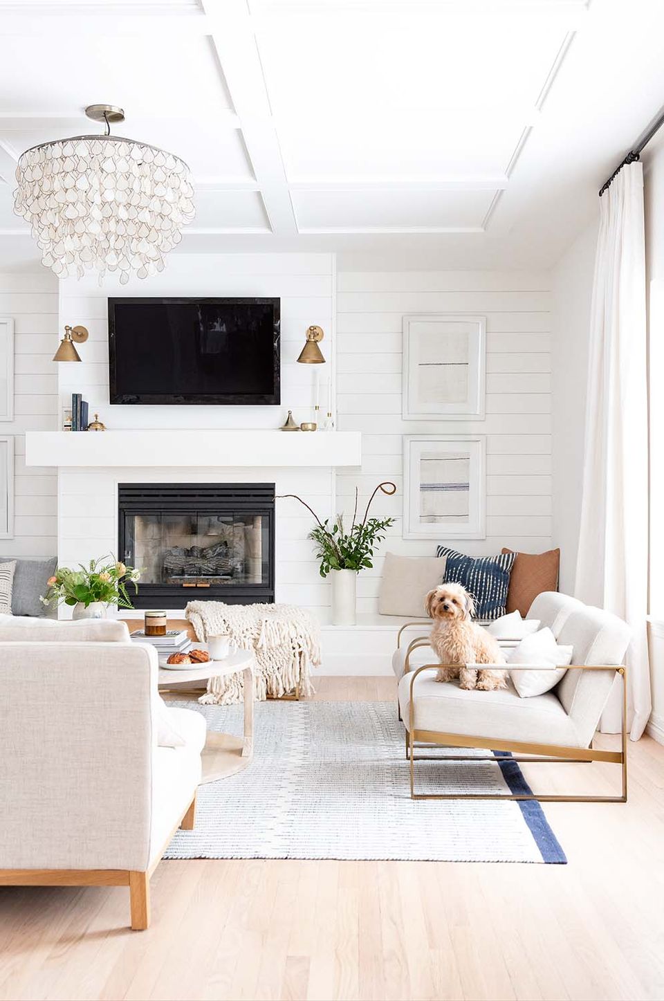 Glamorous living room with crisp white walls, crystal chandelier, and sophisticated neutrals