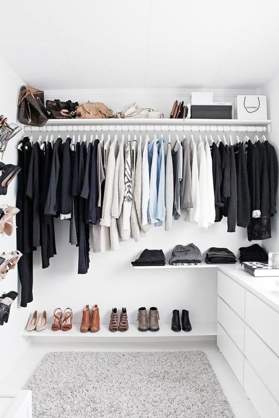 Minimalist capsule closet in monochromatic black, white, and neutral tones with organized display