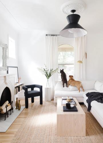 Minimalist Scandinavian bedroom combining crisp whites, warm wood tones, and black accents for serene, organized aesthetic