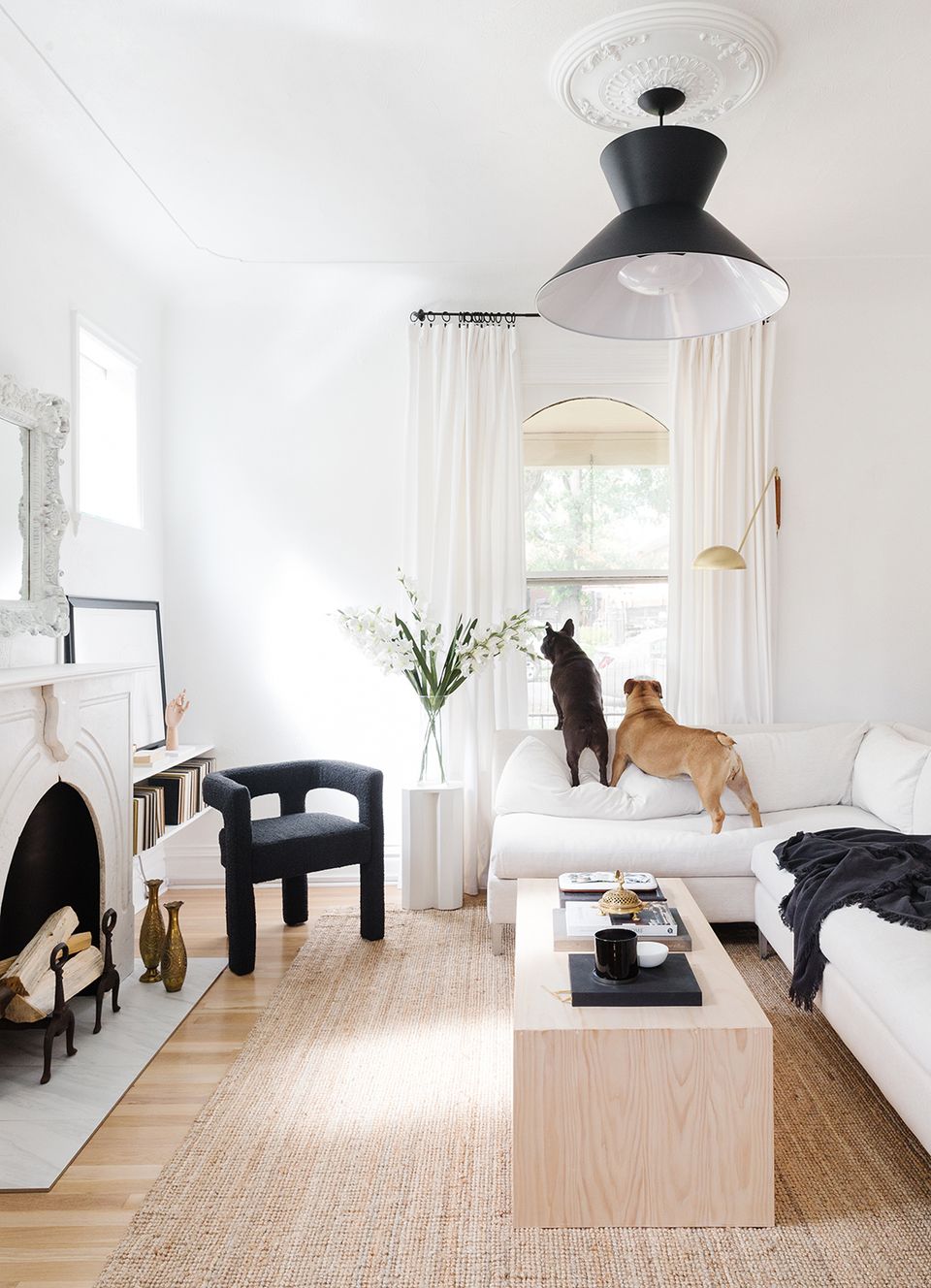 Minimalist Scandinavian bedroom combining crisp whites, warm wood tones, and black accents for serene, organized aesthetic