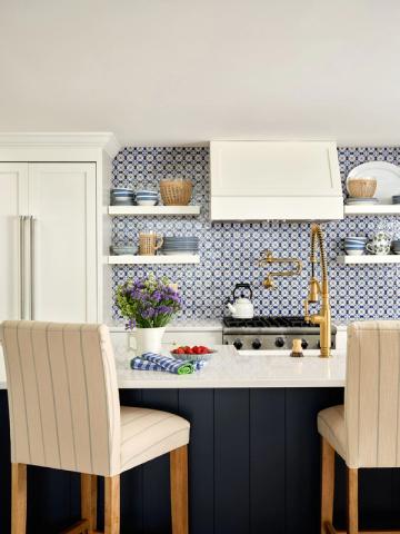 Contemporary kitchen with geometric blue-patterned backsplash, open shelving, and navy island base