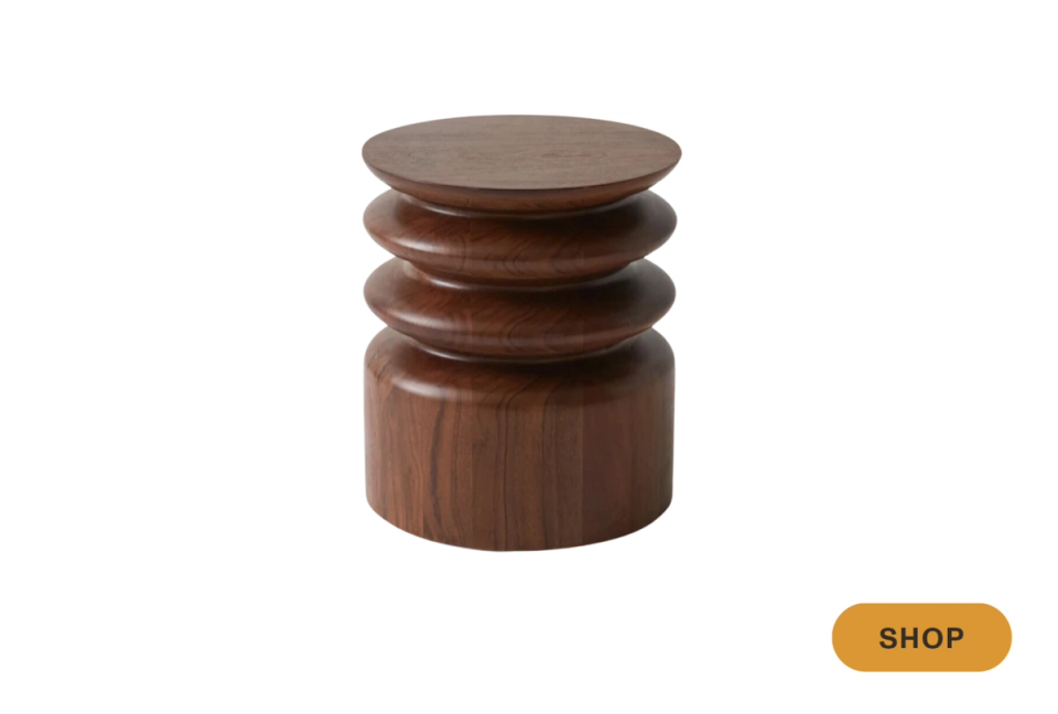 Warm wood-toned cylindrical side table with stacked circular rings, mid-century modern aesthetic