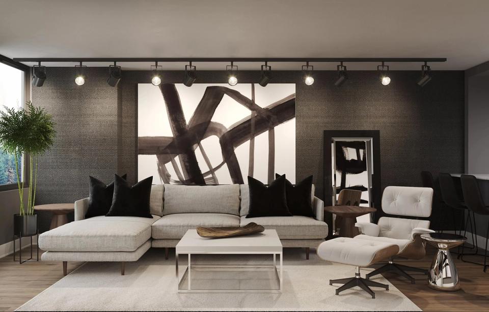 Contemporary space with dramatic black wall art, cream sectional, and minimalist furnishings for urban elegance