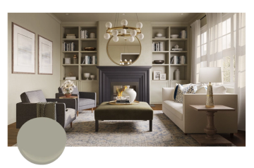 Sophisticated living room featuring sage green walls, dark fireplace, built-in shelving, and neutral upholstered seating