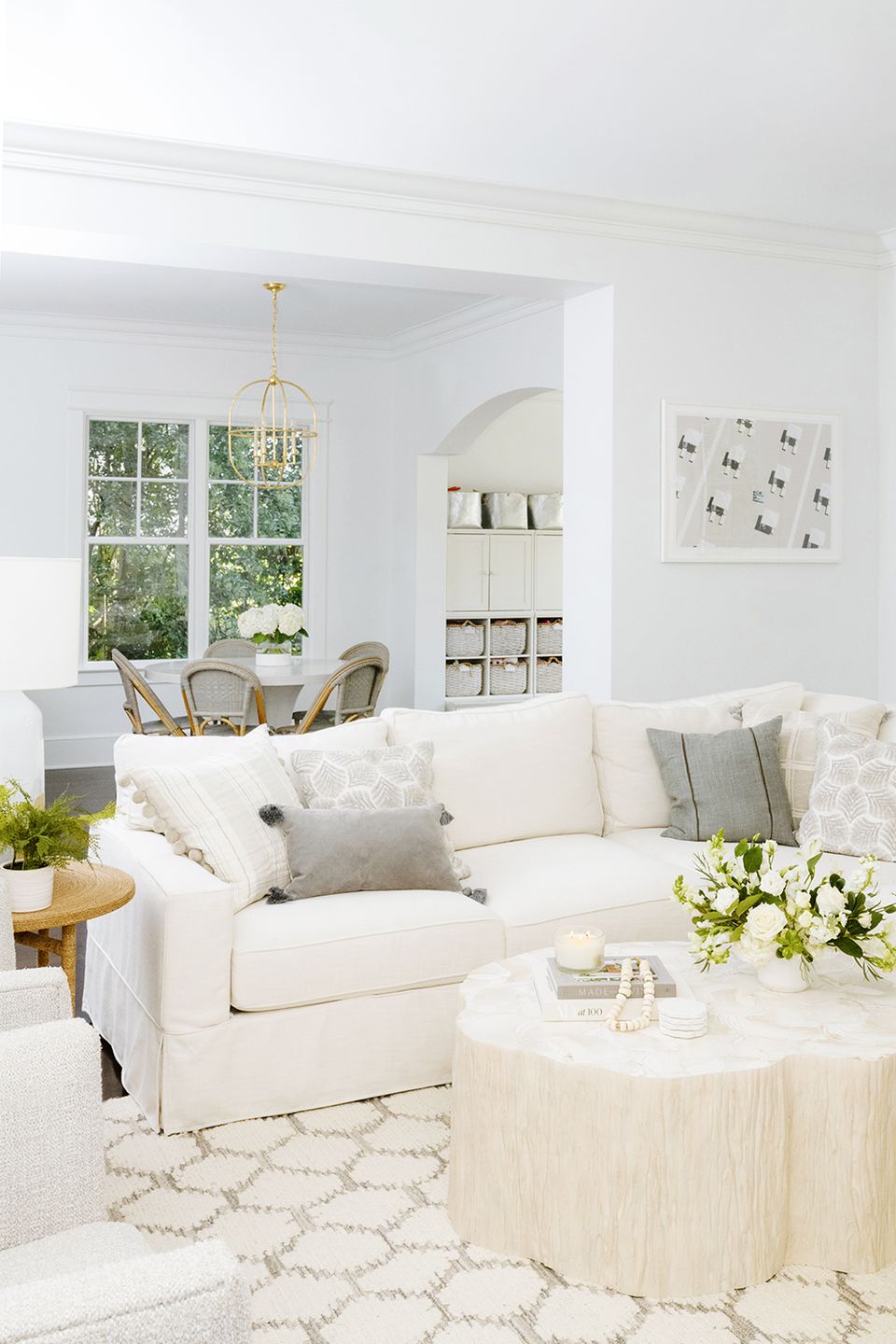 Bright, airy Scandinavian-inspired living room in cream and whites with natural wood touches and minimal, clean-lined furnishings