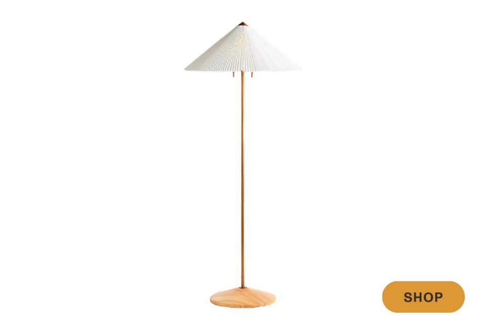 Mid-century modern cone shade on slim brass stem, warm neutral palette