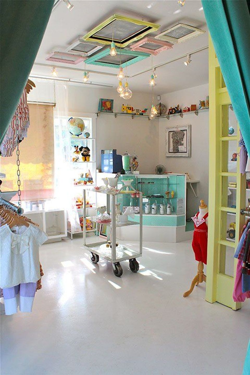 Colorful children's room with turquoise accents, skylights, and playful pendant lighting replacing harsh overhead fluorescents